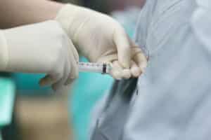 Close up of a provider administering an epidural steroid injections to a patient's back for chronic pan relief.