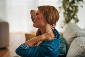 Woman with fibromyalgia experiencing neck pain.